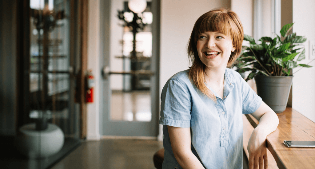 Female leaning against bar smiling